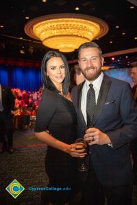 A woman in a black dress and a man in a suit and tie.