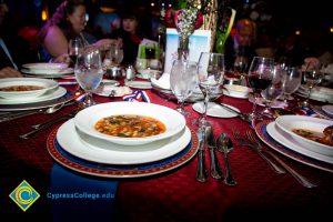 Table setting with a bowl of soup and water glasses.