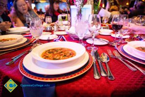 Table setting with a bowl of soup and water glasses.