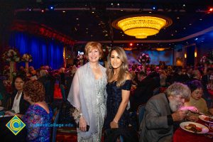 President, JoAnna Schilling with a young lady in a dark blue dress and long brown hair.