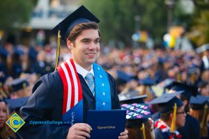 Graduate holding his degree.