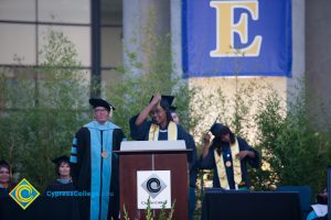 A young lady turning her tassel during commencement.