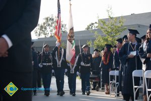 Military Color Guard walking into commencement.