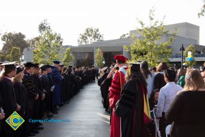 Staff and faculty lining the aisle during commencement procession.