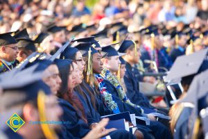 Graduates listening intently during commencement ceremony.