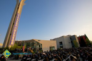 View of commencement ceremony with campanile in the background.