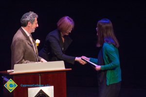 Dr. JoAnna Schilling shakes hands on stage