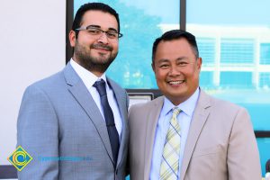 Dr. Paul de Dios in a suit next to man wearing a blue suit and glasses