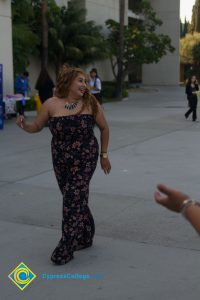 Female student wearing floral strapless jumpsuit and necklace