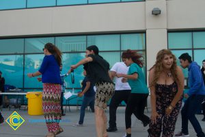 Students and employees dancing near Student Center