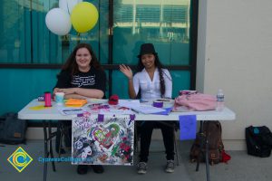 Female students sitting at Lively Arts Club table