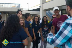 Students in a circle, smiling