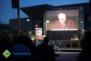 Male Holocaust survivor speaking on stage