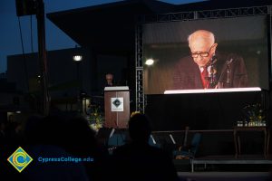 Male Holocaust survivor speaking on stage