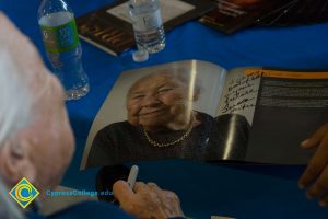 Holocaust Survivor Gerda Seifer signing Yom HaShoah program