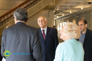 Elderly man wearing dark suit and maroon tie smiling at Cliff Lestor. Also pictured are David Halahmy and Holocaust survivor