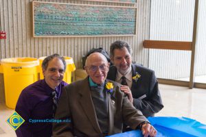 Professor Emeritus Cliff Lester with man in purple dress shirt and male Holocaust survivor