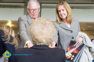 Then-president Bob Simpson and his wife shaking hands with female Holocaust survivor