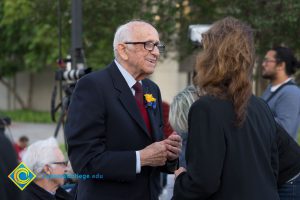 Male Holocaust survivor speaking with woman
