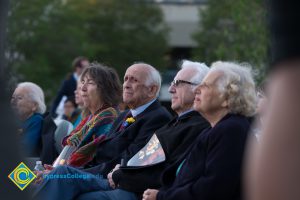 Holocaust survivors sitting next to each other at Yom HaShoah event