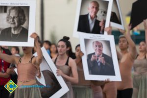 Dancers performing with pictures of Holocaust survivors