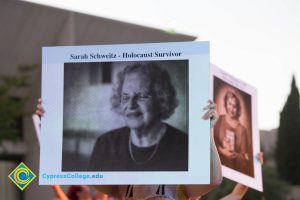 Dancer holding up sign of Holocaust survivor Sarah Schweitz