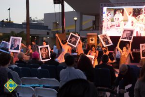 Dancers performing with photos of Holocaust survivors