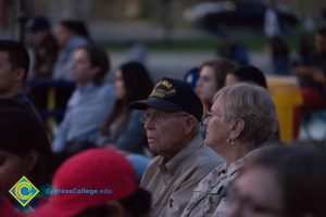 Man wearing World War II hat in audience at Yom HaShoah