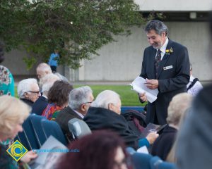 Cliff Lester holding script and talking with Holocaust survivors