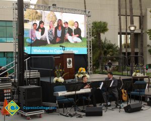 Musicians on stage with projection screen behind them