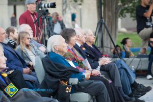 Holocaust survivors seated together watching event
