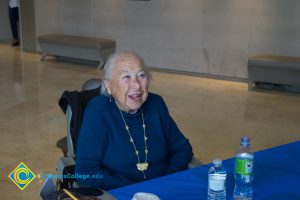 Female Holocaust survivor in wheelchair, sitting at table