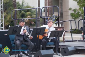 Gary Copar playing trumpet and man playing guitar on stage