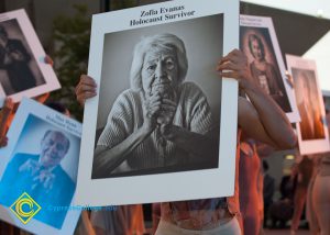Dancer holding up photo of Holocaust Survivor Zofia Evanas