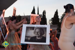 Dancer holding up sign of Holocaust survivor Sarah Schweitz