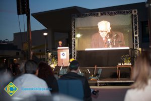 Male Holocaust survivor speaking on stage