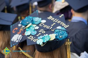 A graduation cap reads "I believed I could so I did" at commencement