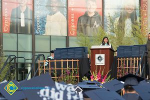 A speaker stands at a podium during commencement