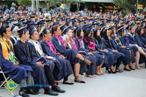 Graduates sit at commencement