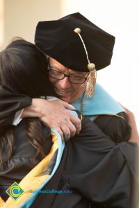 Cypress president hugs a graduate at commencement