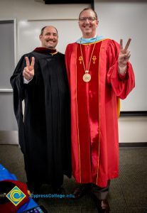 Staff pose in graduation regalia