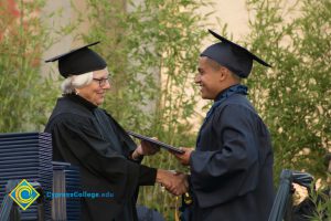 Student receives degree at commencement ceremony