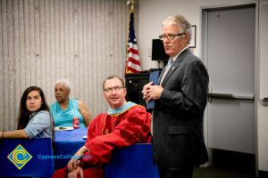 Cypress College president speaks at a meeting