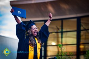 Student receives degree at commencement stage