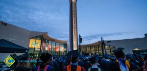 Commencement recession against lit campanile at night