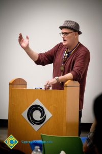 A faculty member speaks at a podium