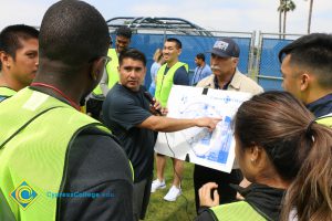 Juan Garcia pointing to a map, sharing the route of the Veterans 5k