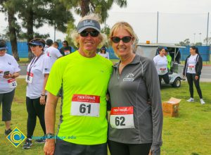 Dr. Bob Simpson and his wife wearing athletic attire with race numbers attached to their shirts
