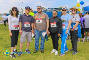 Participants of veterans 5k wearing athletic gear and race numbers