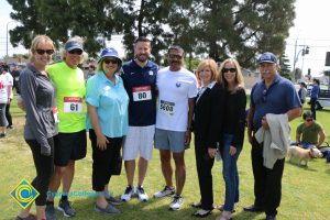 Men and women standing together on the lawn at Veterans 5k